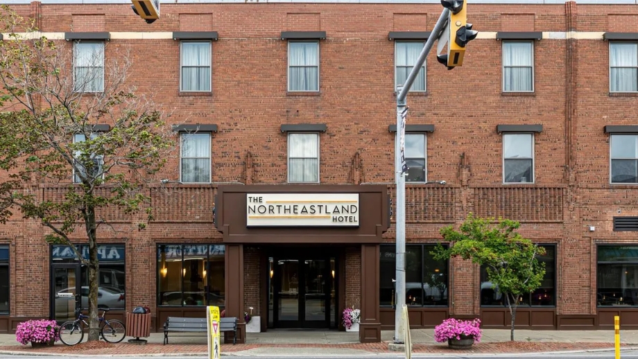 A red brick hotel building with a prominent sign reading 'The Northeastland Hotel'.